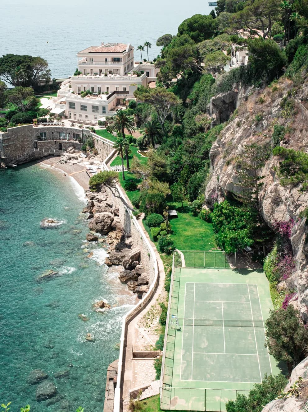 Tennis: a cream villa above a turquoise cove, with a tennis court cut into the cliffside garden